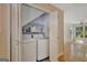 A convenient laundry area with modern washer and dryer units and built-in shelving at 157 Rockspray Rdg, Peachtree City, GA 30269