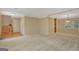 Open living room with neutral walls, carpet, and a view into the dining room and stairway at 157 Rockspray Rdg, Peachtree City, GA 30269