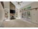 Spacious living room with a stone fireplace, large windows providing natural light and neutral carpeting at 157 Rockspray Rdg, Peachtree City, GA 30269