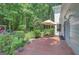Charming patio with patterned tiling, an umbrella, and a view of the verdant backyard at 157 Rockspray Rdg, Peachtree City, GA 30269