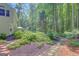 Backyard view of the home bordered with lush, mature landscaping at 157 Rockspray Rdg, Peachtree City, GA 30269