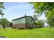 Large, grassy backyard with mature trees and a chain link fence at 7455 Dover Ct, Riverdale, GA 30274