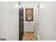 Hallway view of a modern bathroom featuring sleek vanity and decorative wall paneling at 7455 Dover Ct, Riverdale, GA 30274