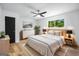Serene bedroom with a ceiling fan, light wood floors and a large bright window at 7455 Dover Ct, Riverdale, GA 30274