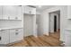 Bright kitchen with white cabinets, quartz countertops, stainless appliances, and wood-look floors at 7455 Dover Ct, Riverdale, GA 30274