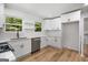Modern kitchen featuring white cabinets, quartz countertops, and stainless steel appliances at 7455 Dover Ct, Riverdale, GA 30274