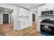 Modern kitchen with white cabinets, quartz countertops, and stainless steel appliances at 7455 Dover Ct, Riverdale, GA 30274