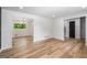 Open living room featuring hardwood floors, white walls and trim, and backyard view at 7455 Dover Ct, Riverdale, GA 30274