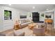 Cozy living room with a black brick fireplace, comfortable seating, and natural light at 7455 Dover Ct, Riverdale, GA 30274