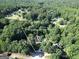 Aerial shot of home in a wooded lot, surrounded by lush trees and foliage at 1315 Crane Ct, Mcdonough, GA 30252