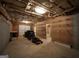 Spacious unfinished basement with exposed ceiling, walls, and a connected garage, ready for customization at 1315 Crane Ct, Mcdonough, GA 30252