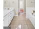 Bright bathroom with double vanity, tile floors, and separate bathtub at 1315 Crane Ct, Mcdonough, GA 30252