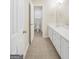 Bright bathroom with double vanity, tile flooring, and an open doorway to a water closet at 1315 Crane Ct, Mcdonough, GA 30252