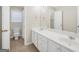 Bright bathroom featuring double vanity with tile flooring and a large mirror at 1315 Crane Ct, Mcdonough, GA 30252