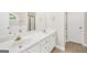 Bathroom features a double vanity, tile floors, and white cabinets at 1315 Crane Ct, Mcdonough, GA 30252