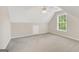 Well-lit attic bedroom featuring neutral walls, carpet, and a bright window with natural light at 1315 Crane Ct, Mcdonough, GA 30252