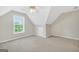 Well-lit attic bedroom featuring neutral walls, carpet, and a bright window with natural light at 1315 Crane Ct, Mcdonough, GA 30252