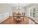 Well-lit dining room with ample seating and natural light from a window at 1315 Crane Ct, Mcdonough, GA 30252