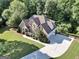 Beautiful brick home features a manicured lawn and a long driveway leading to the garage at 1315 Crane Ct, Mcdonough, GA 30252