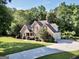 Well-maintained two-story brick home featuring a manicured lawn and a long driveway leading to the garage at 1315 Crane Ct, Mcdonough, GA 30252