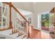 Foyer with wood floors, staircase and a view into the dining room creating a warm and inviting entry at 1315 Crane Ct, Mcdonough, GA 30252