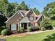 Charming brick home featuring manicured landscaping, a cozy front porch, and classic architectural details at 1315 Crane Ct, Mcdonough, GA 30252