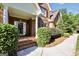 Inviting front porch of a brick home with well-maintained landscaping and a charming entrance at 1315 Crane Ct, Mcdonough, GA 30252