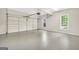 Clean and spacious garage with two windows allowing natural light and a side mounted garage door opener at 1315 Crane Ct, Mcdonough, GA 30252