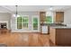 Bright kitchen connects to living room, featuring wood cabinets and backyard access at 1315 Crane Ct, Mcdonough, GA 30252