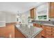Open kitchen with granite counters, an island, and seamless flow to the living area at 1315 Crane Ct, Mcdonough, GA 30252
