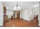 Open kitchen features wood cabinets, island, granite counters, and hardwood floors at 1315 Crane Ct, Mcdonough, GA 30252