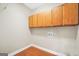 Bright laundry room with wood flooring and built-in cabinetry for added storage solutions at 1315 Crane Ct, Mcdonough, GA 30252