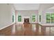 Bright living room with a fireplace, hardwood floors, and large windows overlooking the backyard at 1315 Crane Ct, Mcdonough, GA 30252