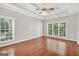 Spacious main bedroom with hardwood floors, tray ceiling, and large windows at 1315 Crane Ct, Mcdonough, GA 30252