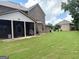 Spacious backyard featuring a well-manicured lawn, a grill, and the house's exterior at 1869 Schofield Dr, Hampton, GA 30228