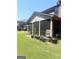 Backyard view of screened in porch, patio furniture, and grill at 1869 Schofield Dr, Hampton, GA 30228