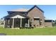 Exterior backyard view with a screened in porch and a brick home at 1869 Schofield Dr, Hampton, GA 30228