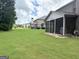 Expansive backyard featuring green grass, trees, and the exterior of the house at 1869 Schofield Dr, Hampton, GA 30228