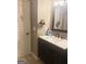 Bathroom featuring a sink with a dark wood vanity, a mirror, and personal care items on the countertop at 1869 Schofield Dr, Hampton, GA 30228
