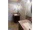 Dual sink bathroom with granite countertops, decorative tile backsplash, and stylish lighting at 1869 Schofield Dr, Hampton, GA 30228