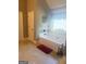 Bright bathroom with a soaking tub under a window, adjacent to the shower at 1869 Schofield Dr, Hampton, GA 30228