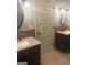 Double vanity bathroom with granite countertops, mosaic tile backsplash, and framed mirrors creating a luxurious and functional space at 1869 Schofield Dr, Hampton, GA 30228