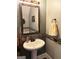 Powder bathroom featuring a pedestal sink, decorative mirror, and mosaic tile accents at 1869 Schofield Dr, Hampton, GA 30228
