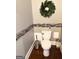 Bathroom featuring mosaic tile details, decorative wreath, and stainless steel trash can at 1869 Schofield Dr, Hampton, GA 30228