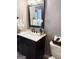 Half bathroom featuring a dark wood vanity, marble countertops, and neutral paint at 1869 Schofield Dr, Hampton, GA 30228