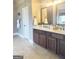 Bathroom with double sink vanity, decorative mirrors, updated faucets, and ample counter space at 1869 Schofield Dr, Hampton, GA 30228
