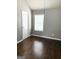 Bright bedroom features hardwood floors, a window with blinds, and neutral paint colors at 1869 Schofield Dr, Hampton, GA 30228