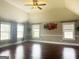 Large bedroom with vaulted ceiling, three windows, and dark hardwood floors at 1869 Schofield Dr, Hampton, GA 30228
