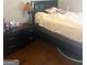 Bedroom featuring dark wood floors, a bed with a black headboard, and two black nightstands with lamps at 1869 Schofield Dr, Hampton, GA 30228