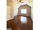 The spacious bedroom has vaulted ceilings, a window, and wood floors at 1869 Schofield Dr, Hampton, GA 30228